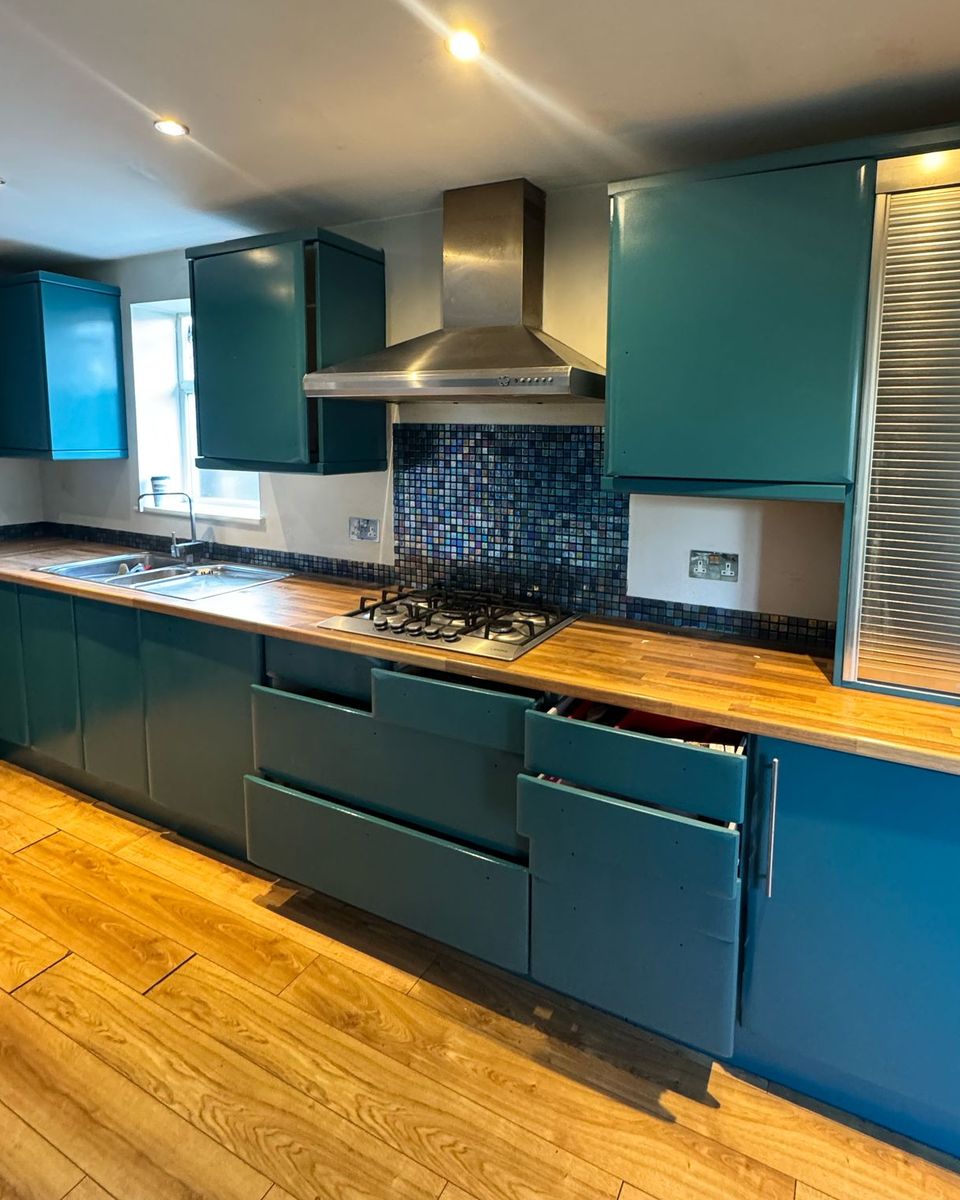 White gloss kitchen resprayed in deep teal