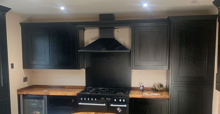 Black shaker kitchen with range cooker and walnut worktops