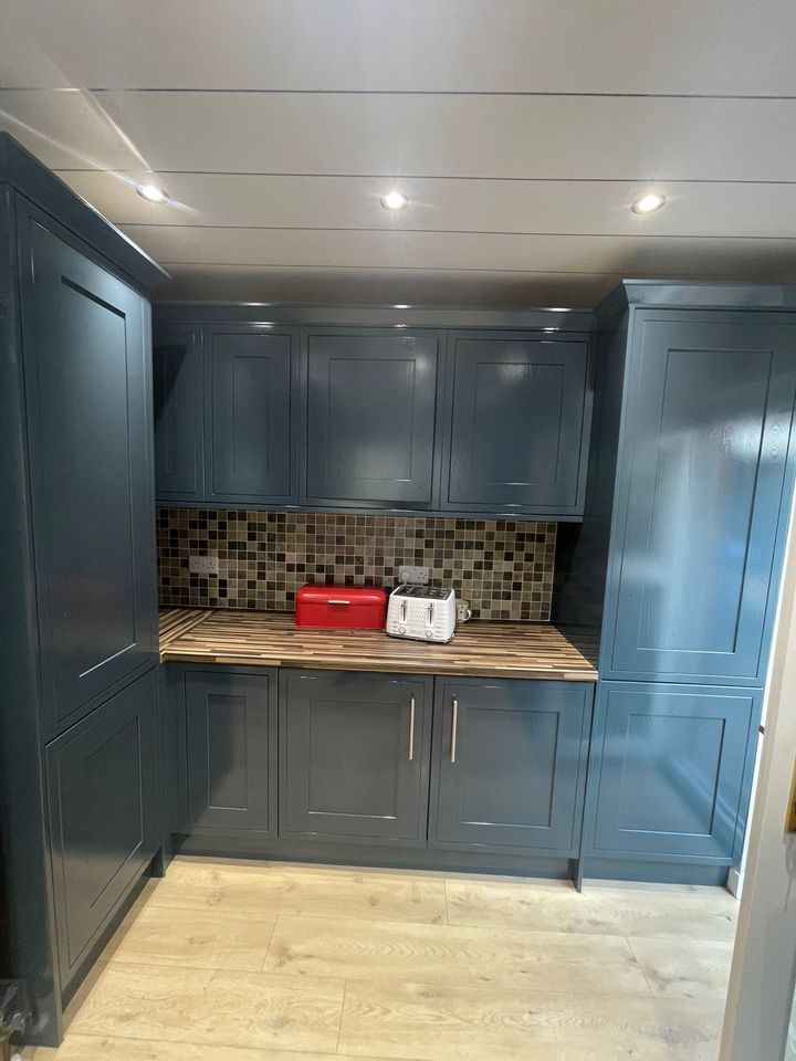 Dark teal shaker kitchen with walnut worktop after respraying
