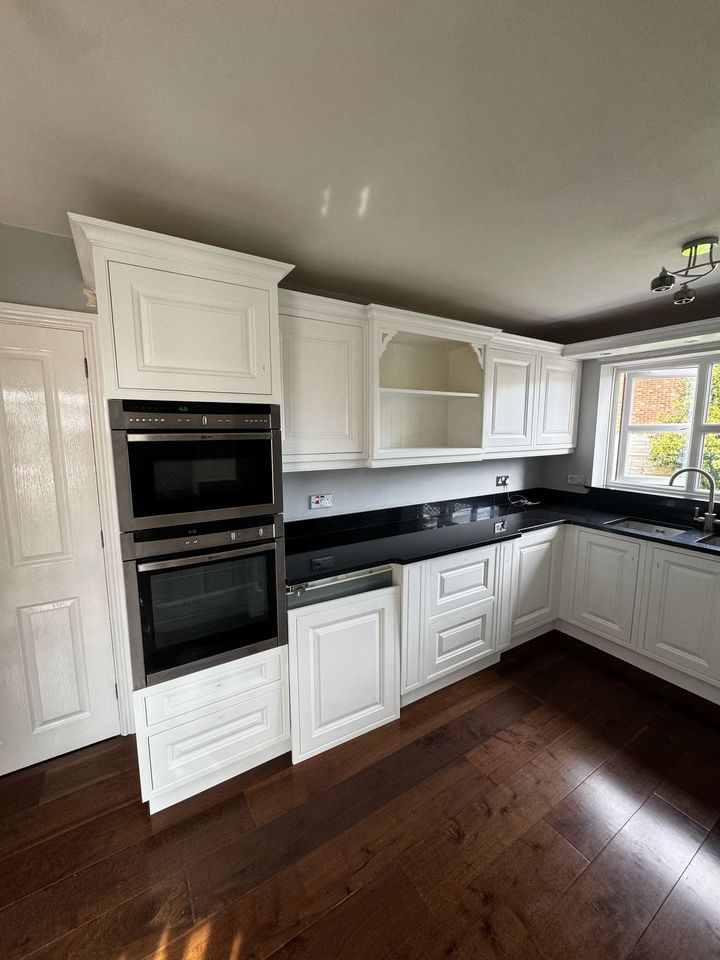 White traditional kitchen with black granite worktops after respraying