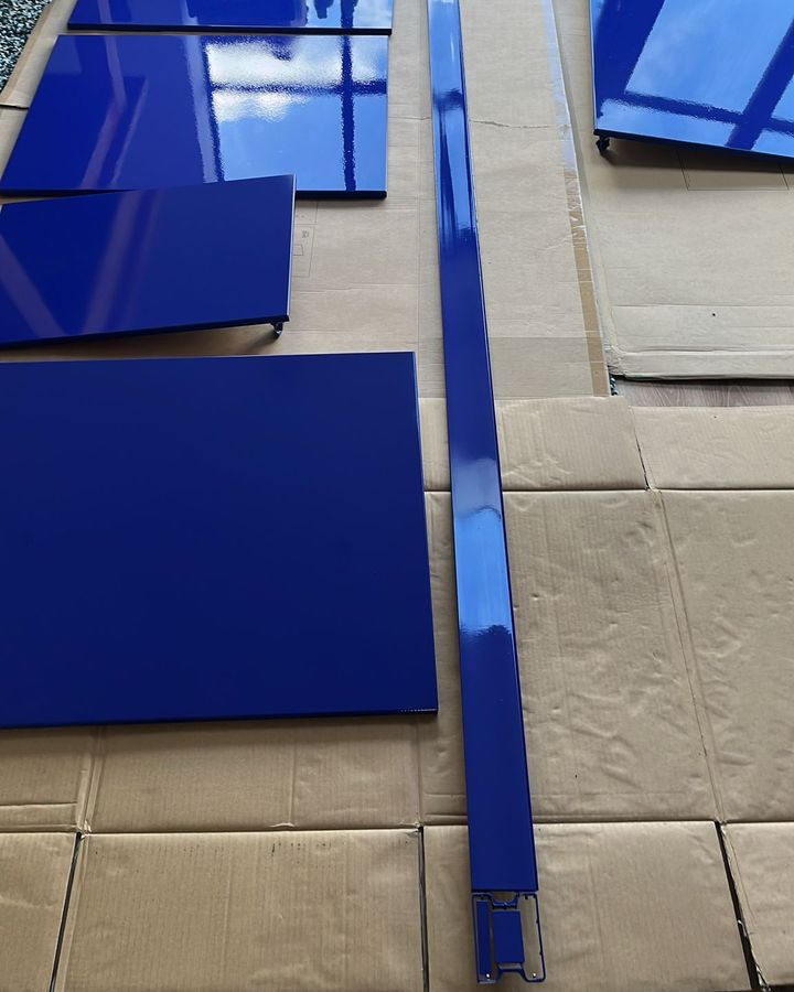 Freshly sprayed cobalt blue kitchen doors laid out to cure